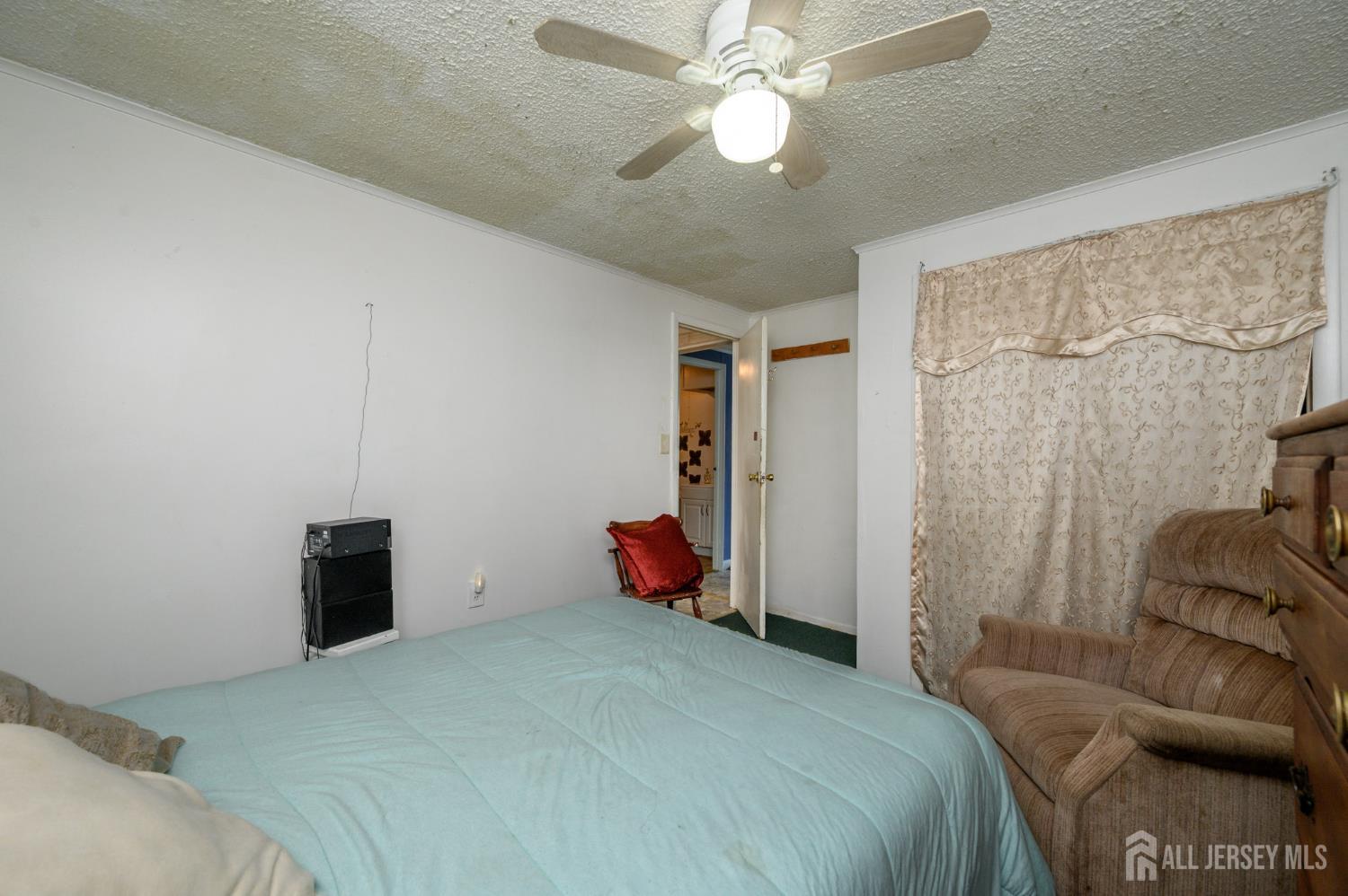 8 Snow Chief Court Howell, NJ 07731 - Photo 14 of 26 a bedroom with a bed and a couch