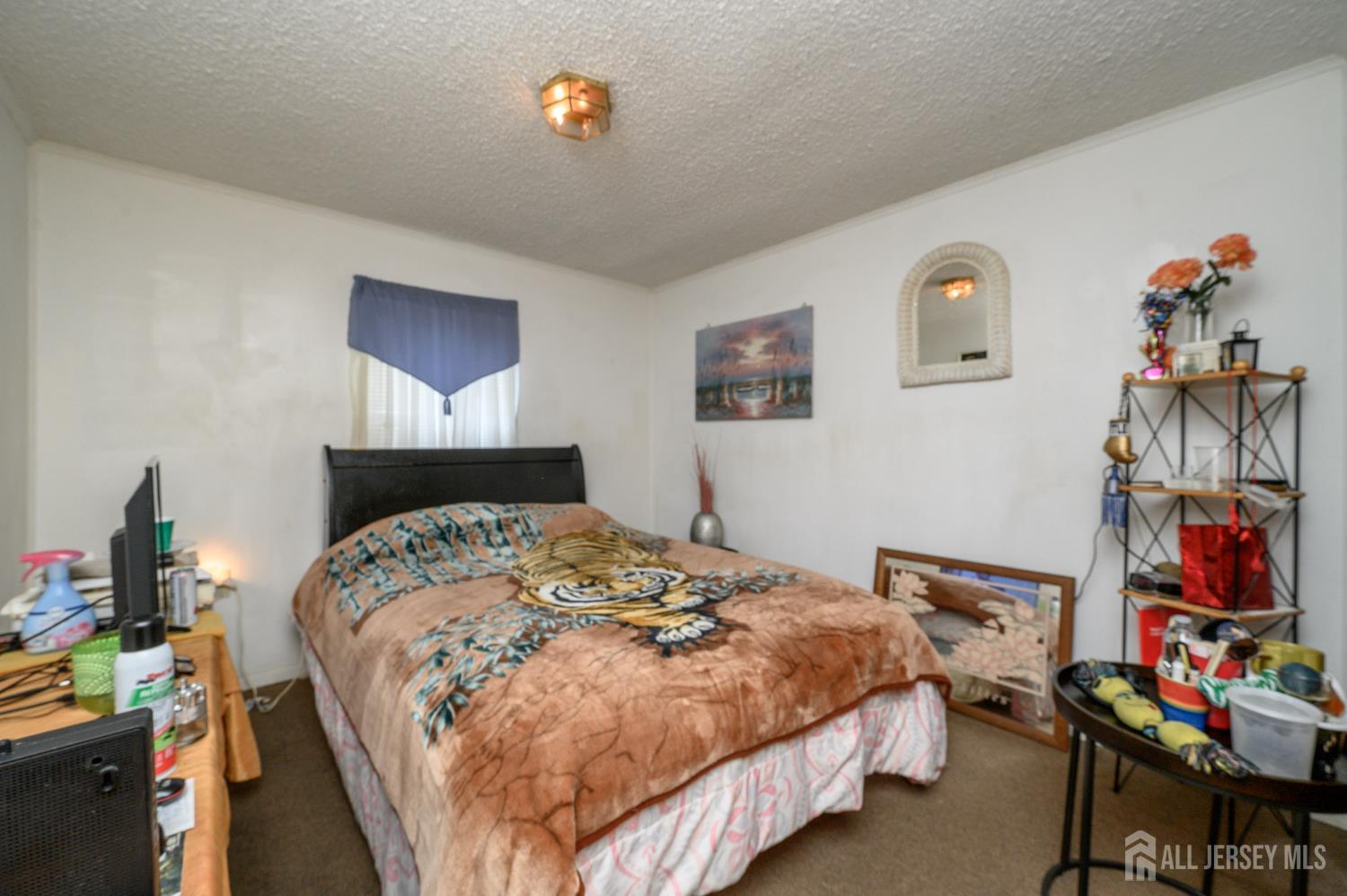 8 Snow Chief Court Howell, NJ 07731 - Photo 16 of 26 a bedroom with bed and a chandelier