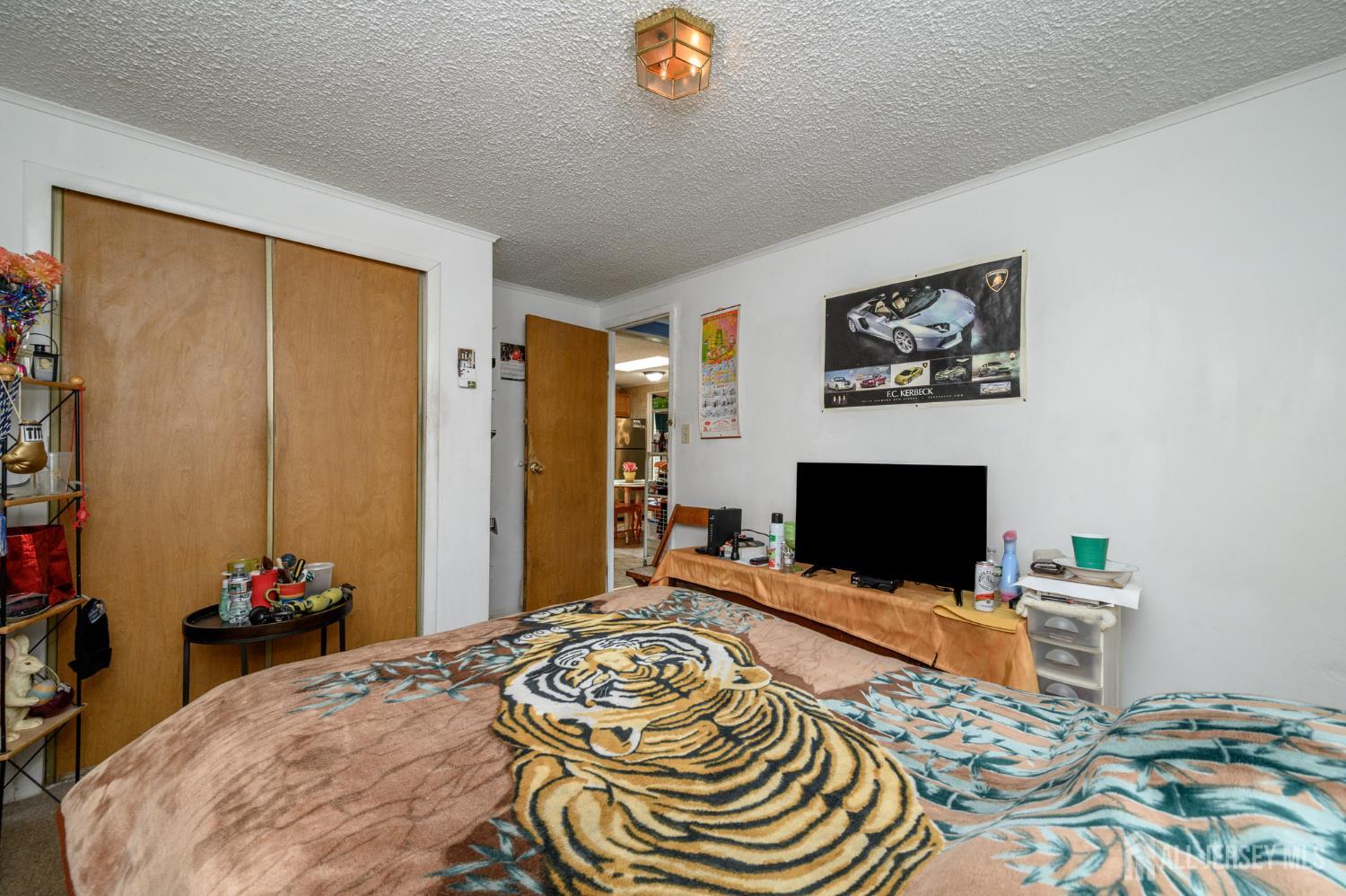 8 Snow Chief Court Howell, NJ 07731 - Photo 17 of 26 a bedroom with furniture and a flat screen tv