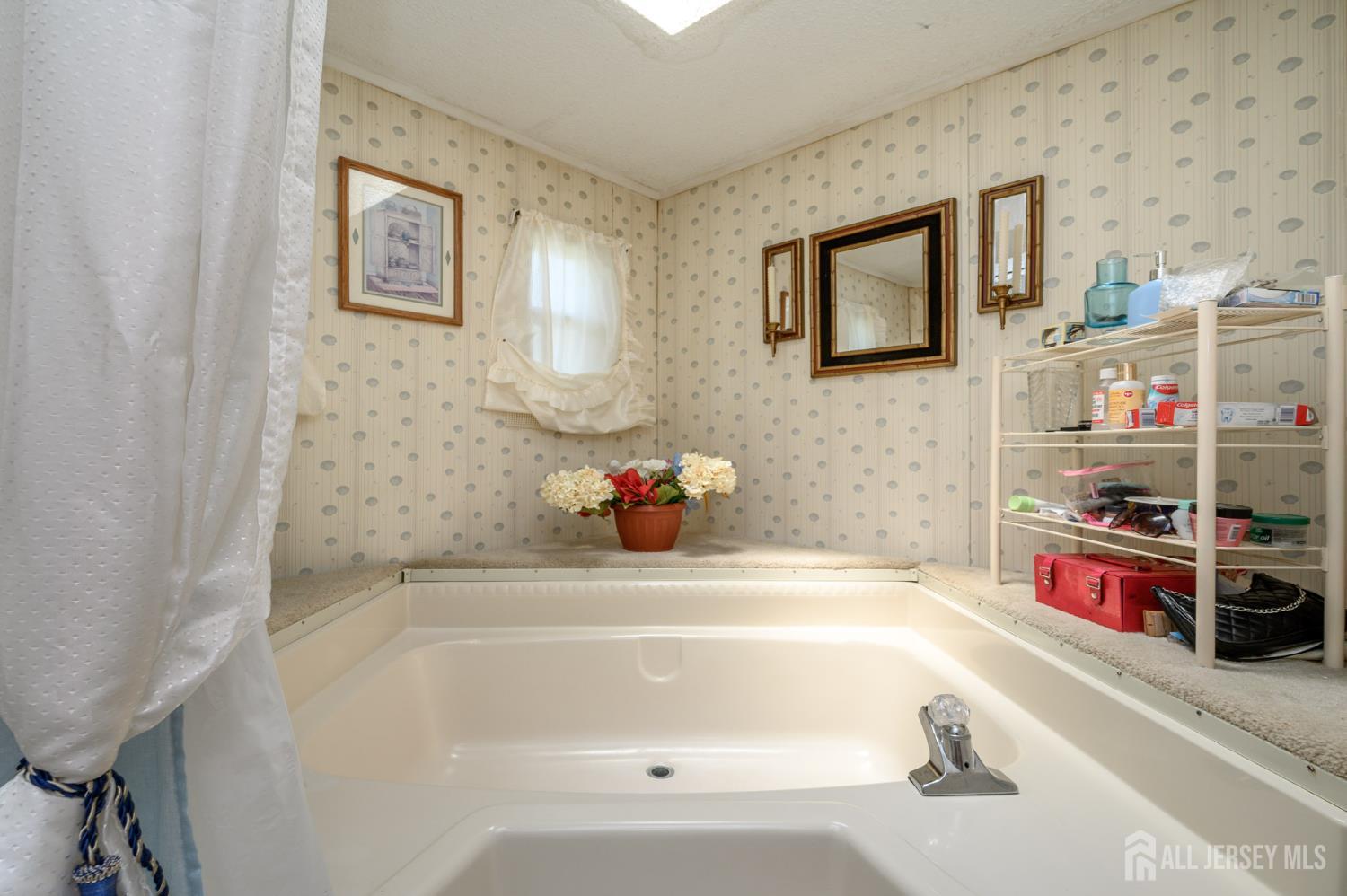 8 Snow Chief Court Howell, NJ 07731 - Photo 21 of 26 a bathroom with a bathtub and a shower