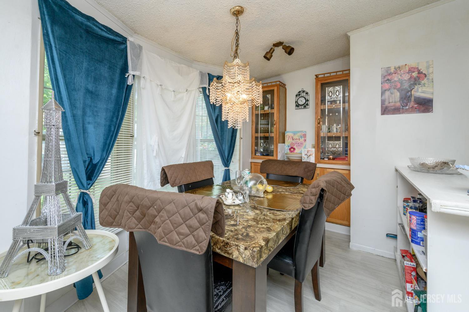 8 Snow Chief Court Howell, NJ 07731 - Photo 7 of 26 a view of a dining room with furniture and wooden floor