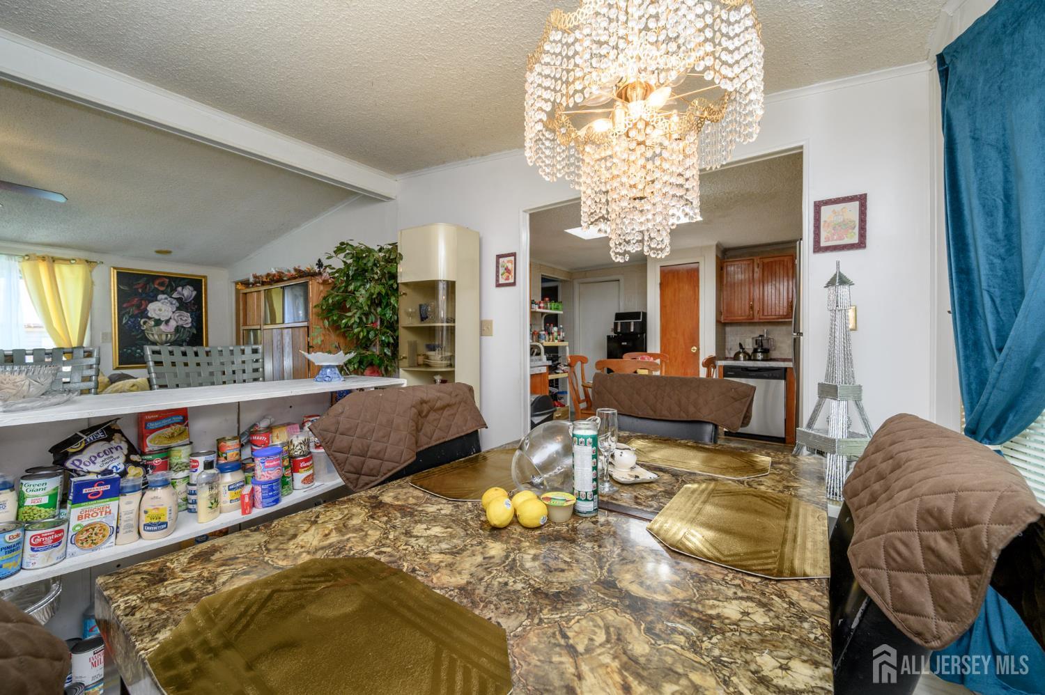 8 Snow Chief Court Howell, NJ 07731 - Photo 8 of 26 a living room with furniture and a chandelier