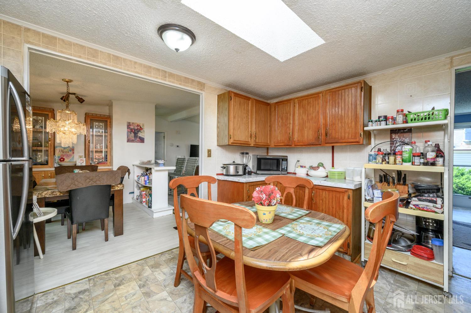 8 Snow Chief Court Howell, NJ 07731 - Photo 10 of 26 a living room with dining room and kitchen view