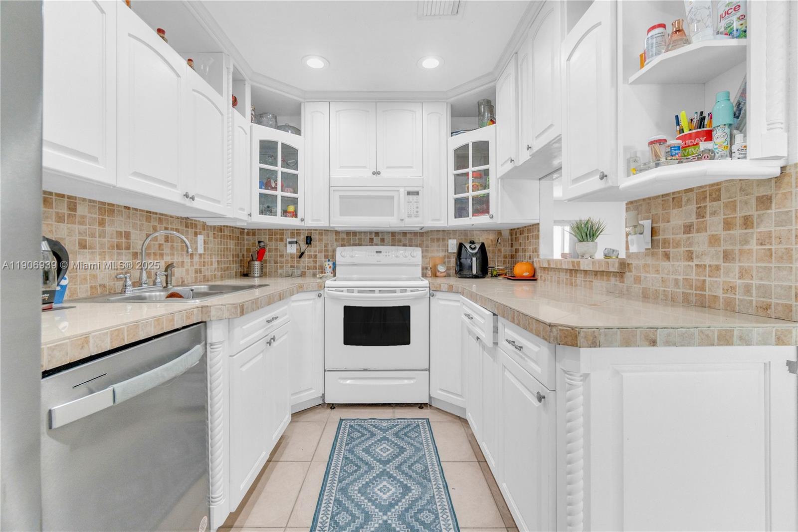 13715 Southwest 84th Street, Unit F Miami, FL 33143 - Photo 12 of 30 a kitchen with stainless steel appliances granite countertop a sink and cabinets