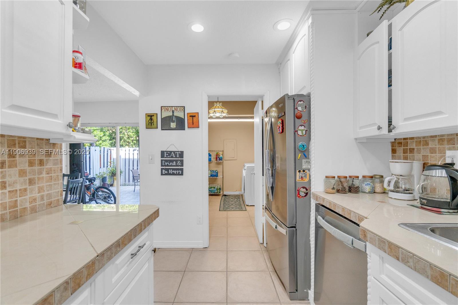 13715 Southwest 84th Street, Unit F Miami, FL 33143 - Photo 15 of 30 a kitchen with stainless steel appliances granite countertop a refrigerator and a sink