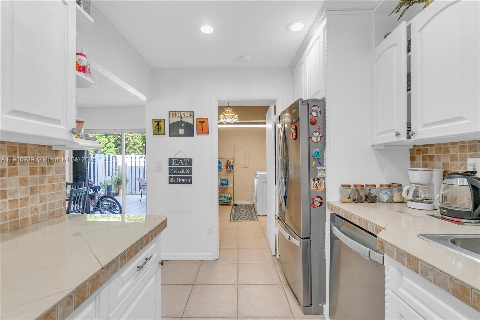 13715 Southwest 84th Street, Unit F Miami, FL 33143 - Photo 15 of 30 a kitchen with stainless steel appliances granite countertop a refrigerator and a sink