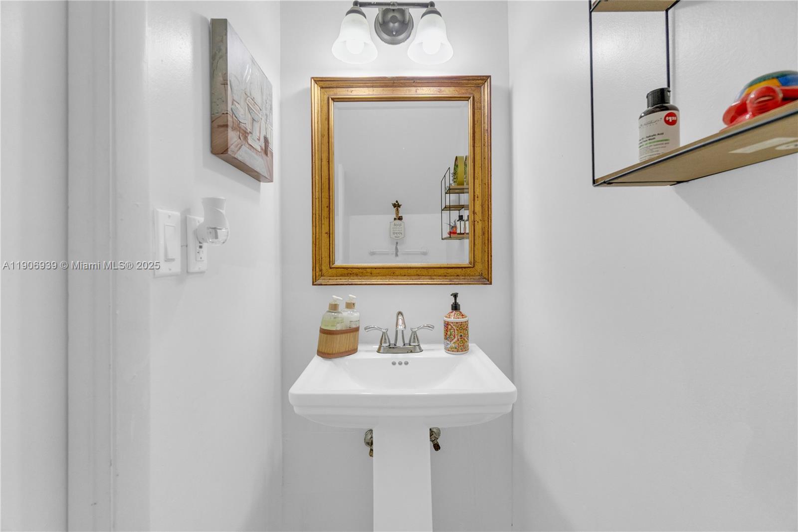 13715 Southwest 84th Street, Unit F Miami, FL 33143 - Photo 17 of 30 a bathroom with a sink and a mirror