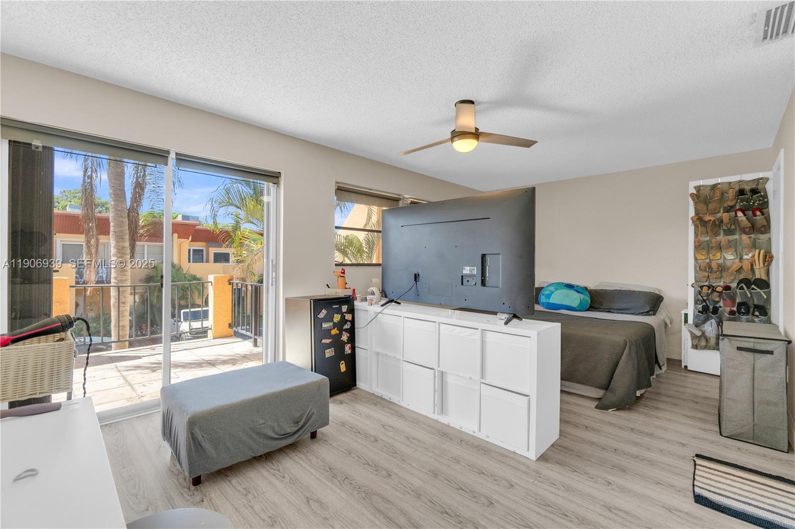 13715 Southwest 84th Street, Unit F Miami, FL 33143 - Photo 19 of 30 a living room with furniture and a large window