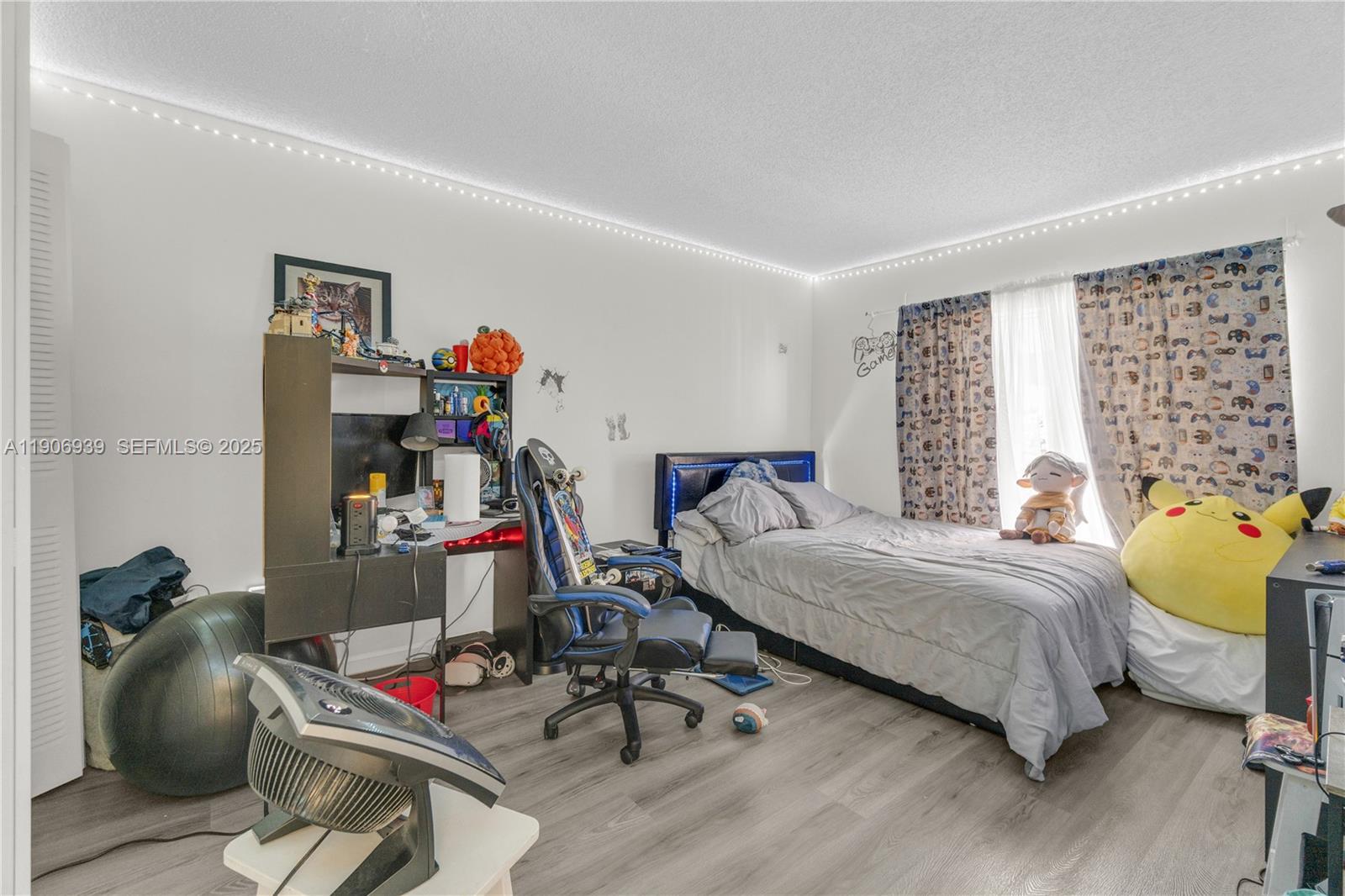 13715 Southwest 84th Street, Unit F Miami, FL 33143 - Photo 25 of 30 a bedroom with bed and a couch