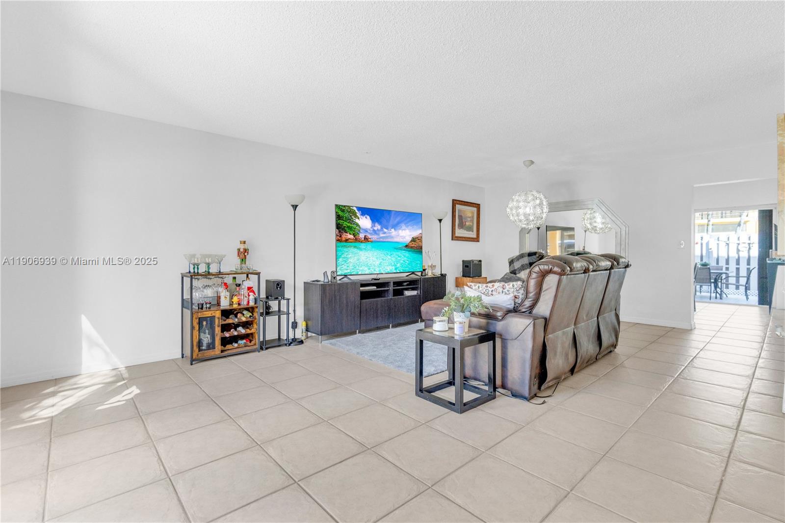 13715 Southwest 84th Street, Unit F Miami, FL 33143 - Photo 4 of 30 a living room with furniture and a flat screen tv