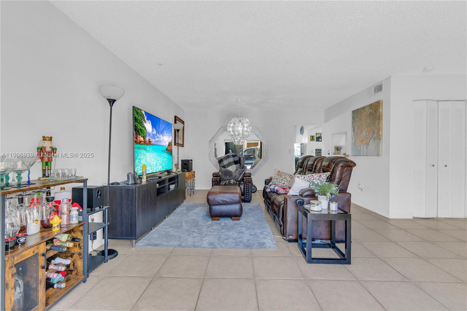 13715 Southwest 84th Street, Unit F Miami, FL 33143 - Photo 5 of 30 a living room with lots of furniture and a flat screen tv