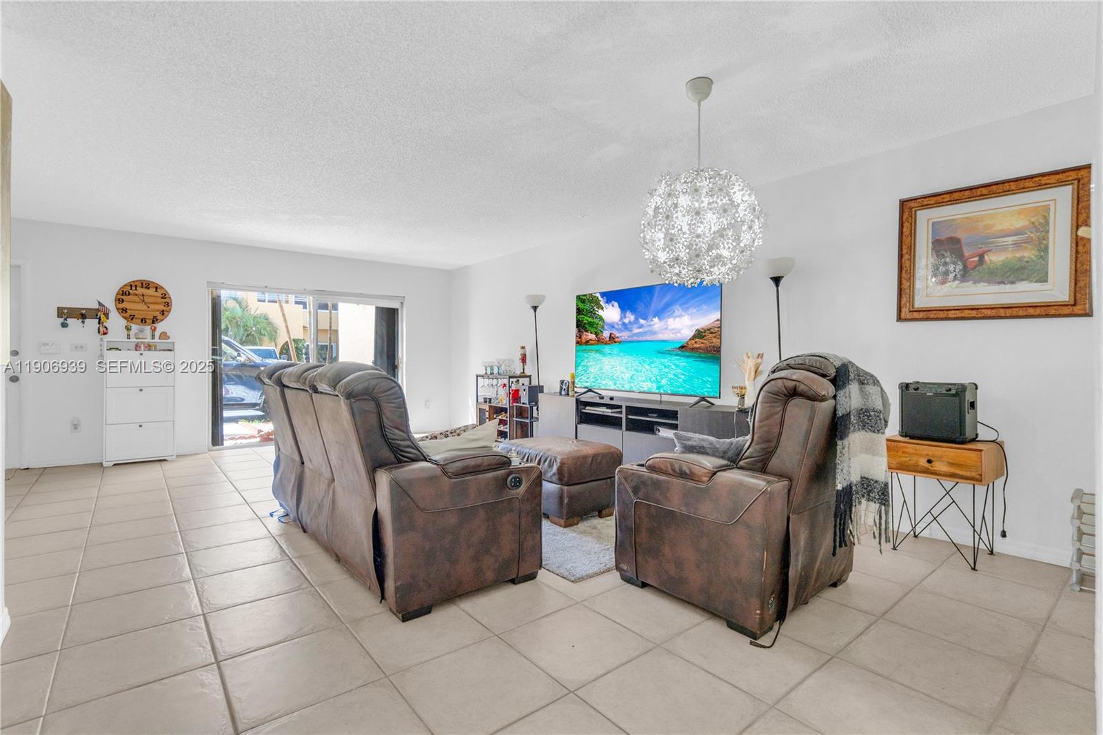 13715 Southwest 84th Street, Unit F Miami, FL 33143 - Photo 6 of 30 a living room with furniture and a flat screen tv