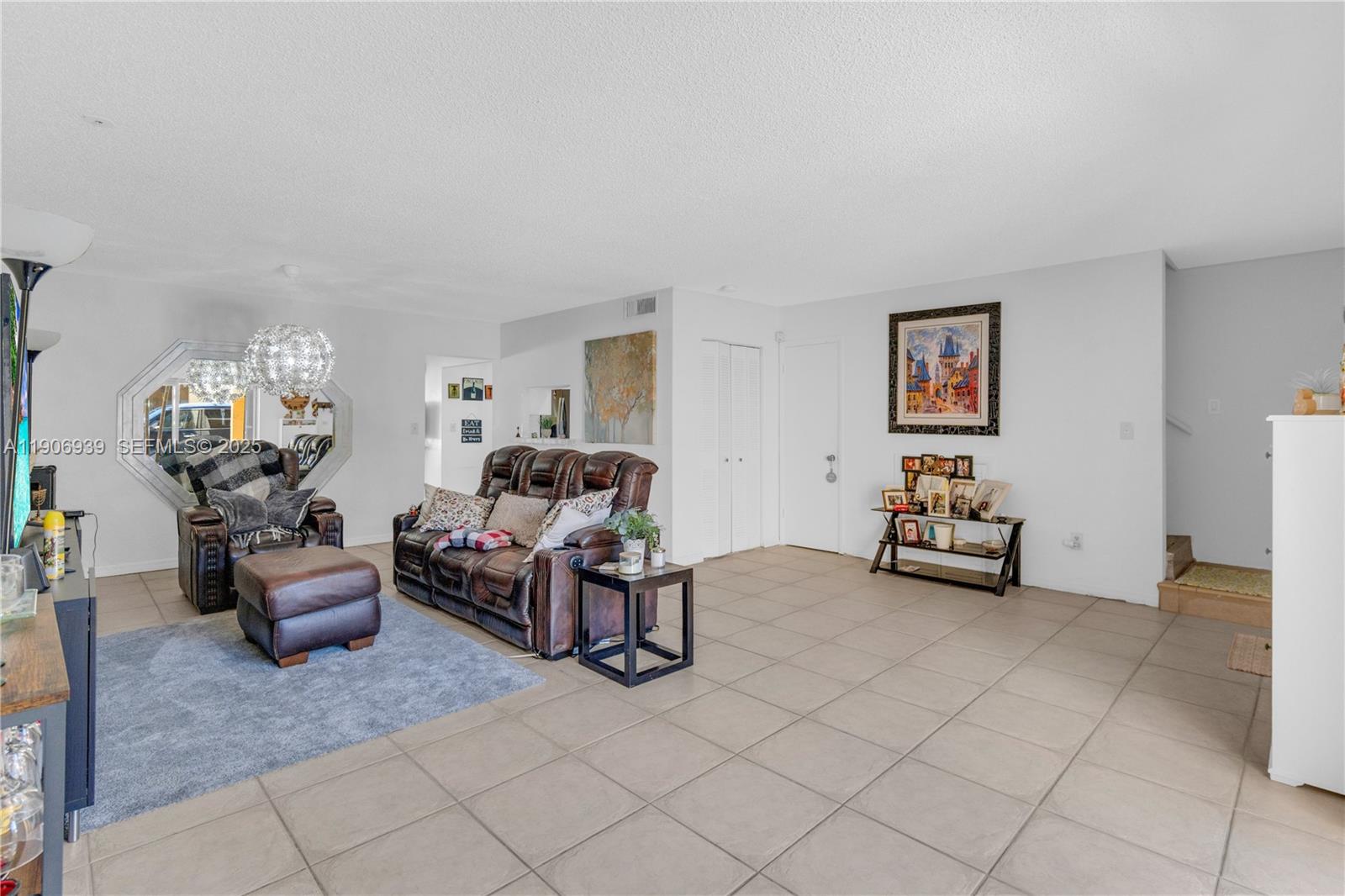 13715 Southwest 84th Street, Unit F Miami, FL 33143 - Photo 8 of 30 a living room with furniture and a table