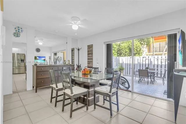 a outdoor space with furniture a large window and white appliances