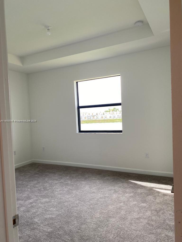 10166 Southwest 228th Terrace Miami, FL 33190 - Photo 16 of 29 an empty room with a window