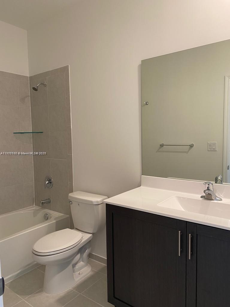 10166 Southwest 228th Terrace Miami, FL 33190 - Photo 17 of 29 a bathroom with a sink a toilet and shower