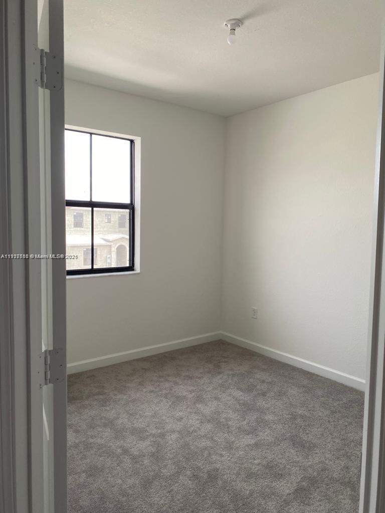 10166 Southwest 228th Terrace Miami, FL 33190 - Photo 19 of 29 an empty room with a window