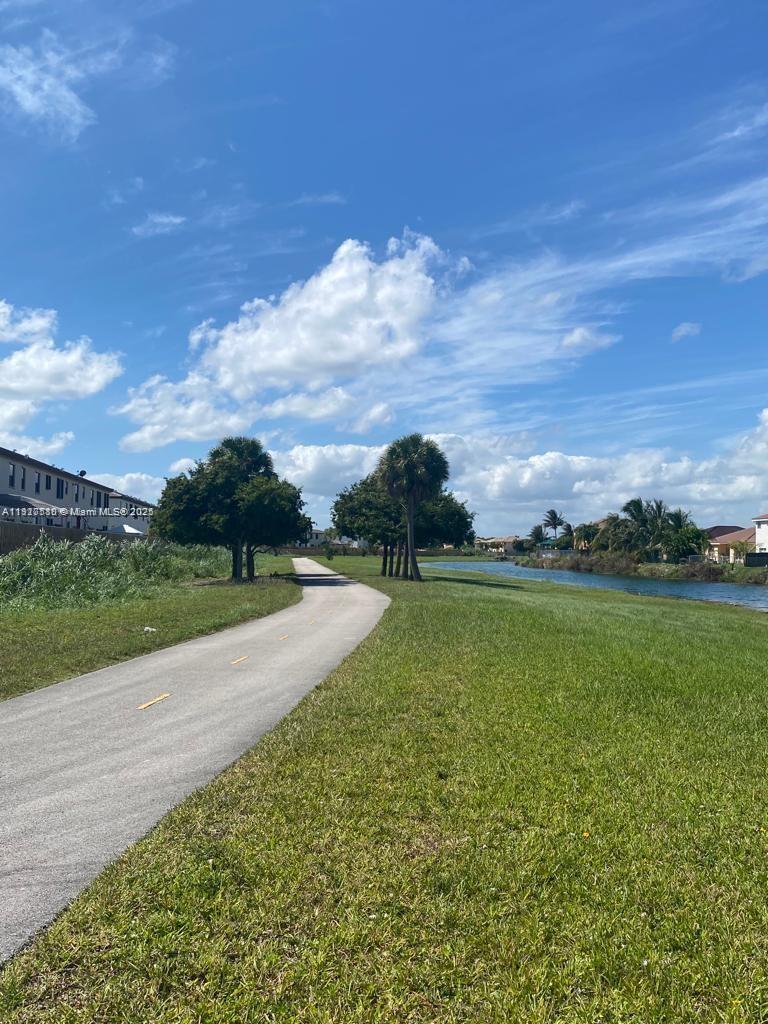 10166 Southwest 228th Terrace Miami, FL 33190 - Photo 8 of 29 a view of a lake with a yard