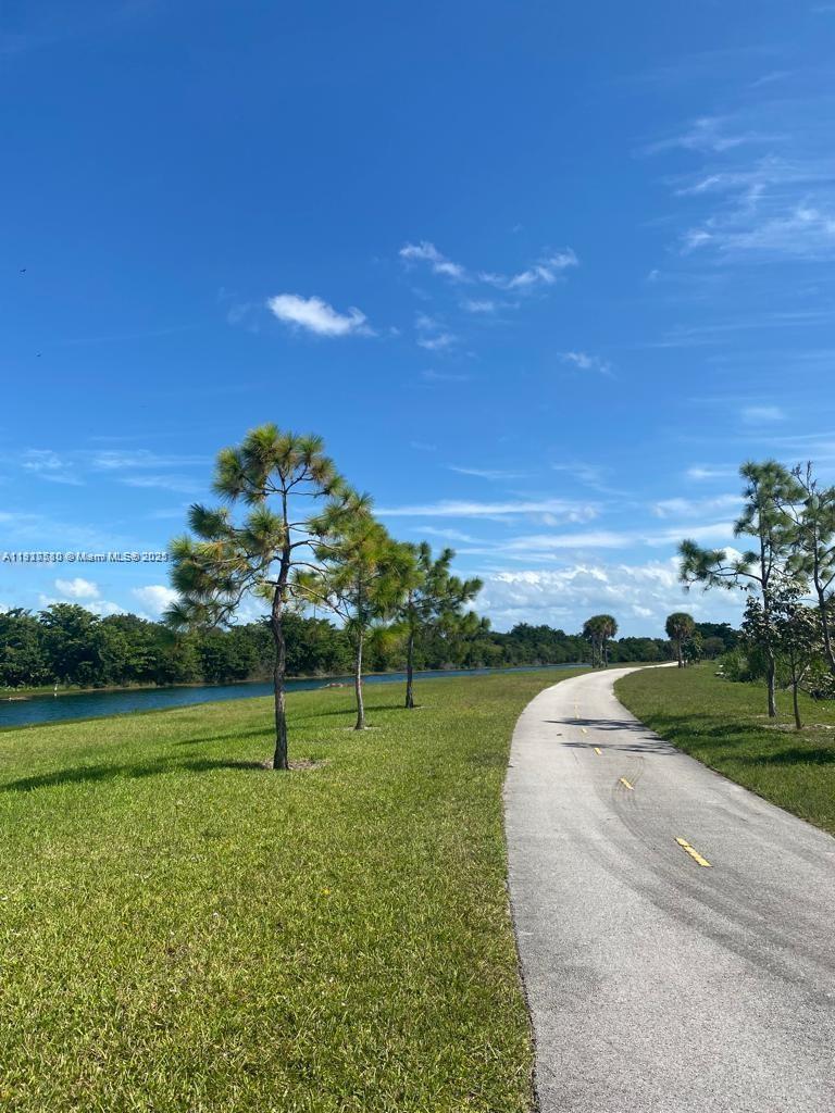 10166 Southwest 228th Terrace Miami, FL 33190 - Photo 9 of 29 a view of a golf course with a palm tree