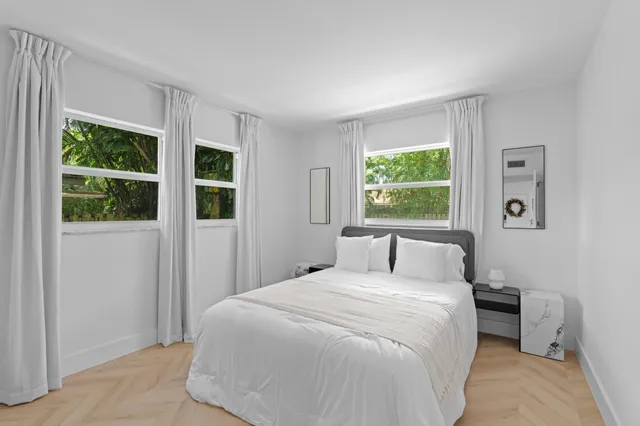 a bedroom with a large bed and a window