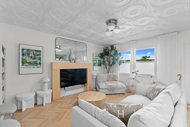 a living room with furniture a fireplace and a flat screen tv