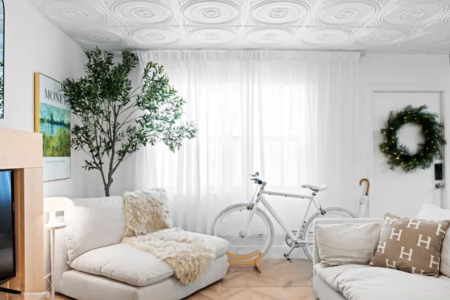 a living room with furniture and a large mirror