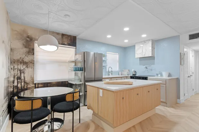 a kitchen with a table chairs sink and cabinets