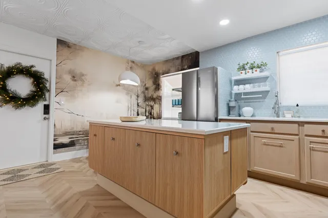 a kitchen with granite countertop a sink and cabinets