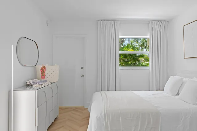 a bedroom with a bed a window and a window