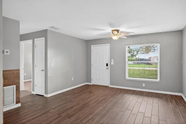 wooden floor in an empty room with a window