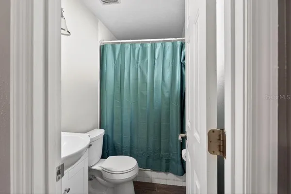 a bathroom with a toilet a sink and a shower