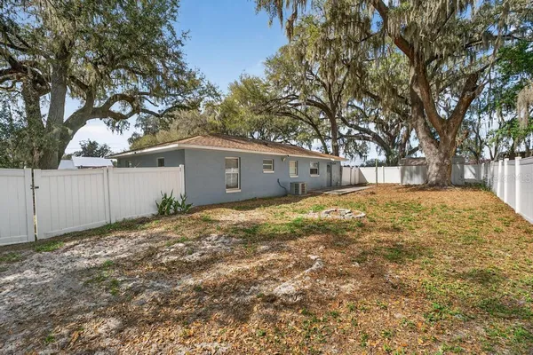 a view of a yard with a large tree