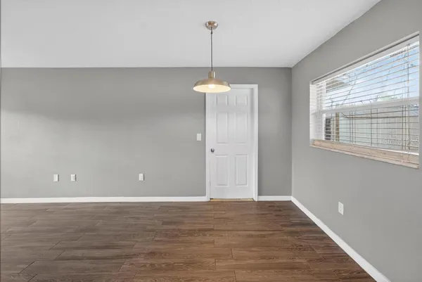 a view of a room with wooden floor and a window