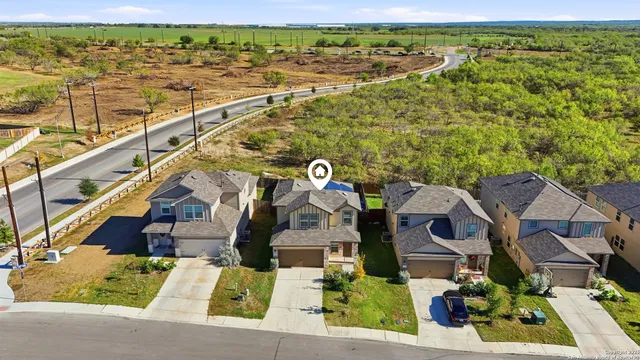 an aerial view of residential houses with outdoor space