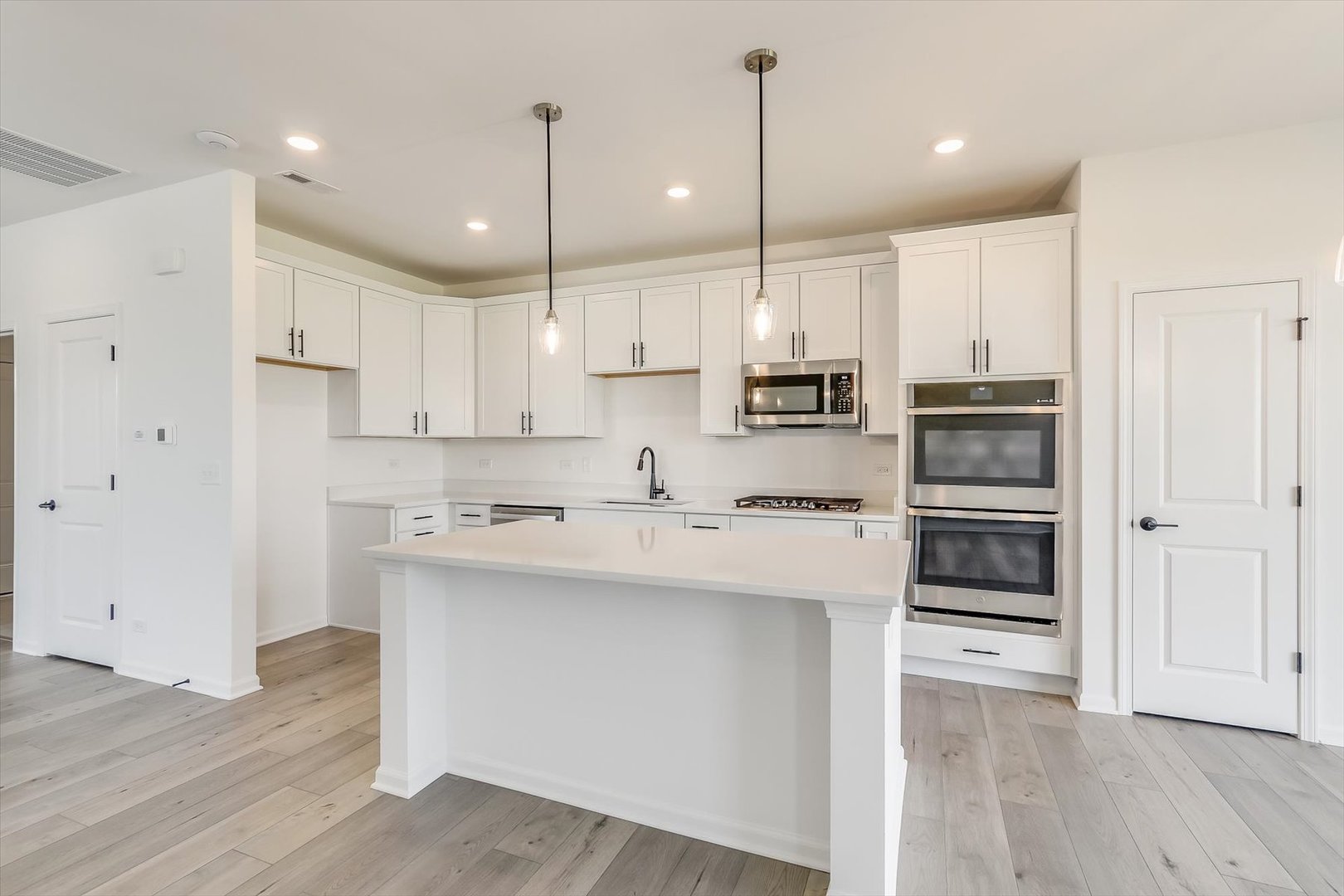 730 Alberta Avenue Oswego, IL 60543 - Photo 14 of 29 a kitchen with kitchen island white cabinets and stainless steel appliances