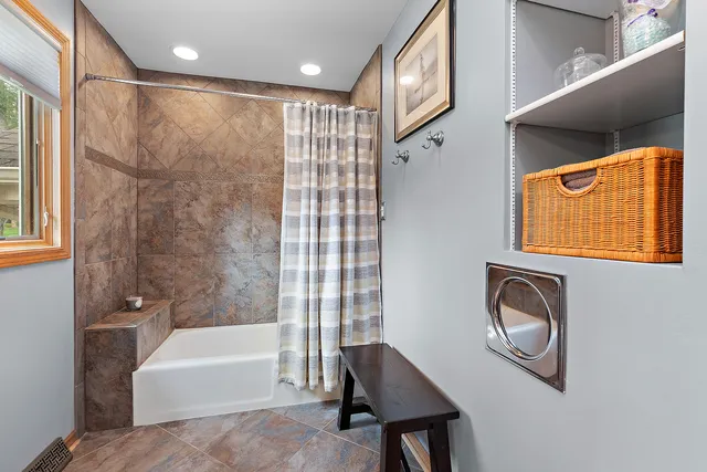 a bathroom with a bathtub a shower and a sink