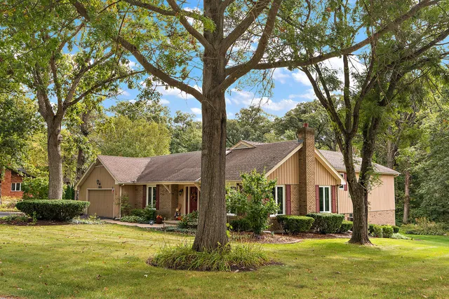 a front view of a house with a yard table and chairs