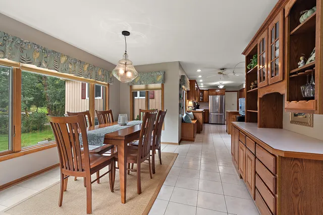 a dining room with furniture entryway and wooden floor