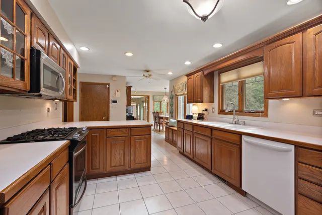 a kitchen with stainless steel appliances granite countertop a stove sink and cabinets