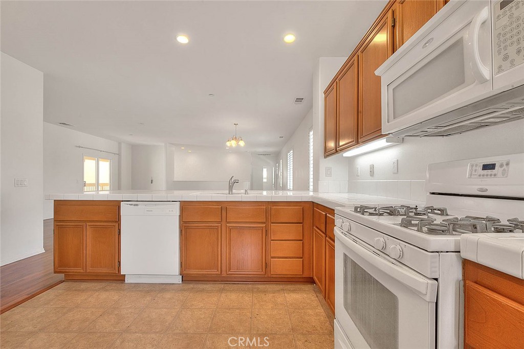 8150 West Preserve Loop Chino, CA 91708 - Photo 27 of 51 a kitchen with stainless steel appliances granite countertop a stove a sink and a refrigerator