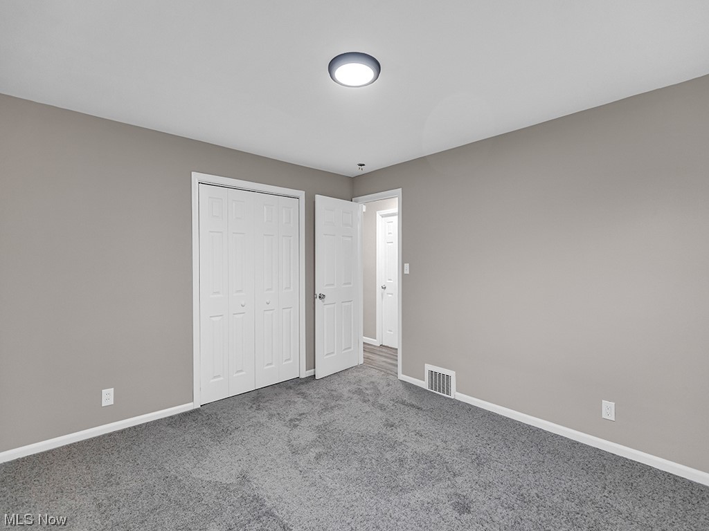 1661 Rush Road Wickliffe, OH 44092 - Photo 12 of 26 Unfurnished bedroom featuring a closet and dark colored carpet
