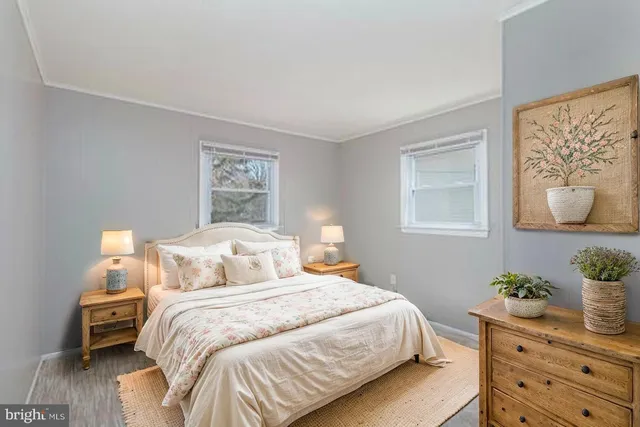 a bedroom with a bed and a painting on the wall