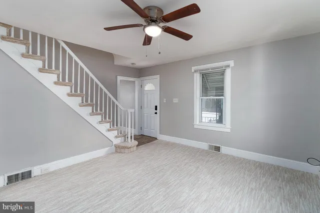 a view of room with window ceiling fan and hardwood floor