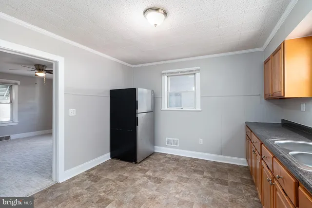 an empty room with window and wooden floor