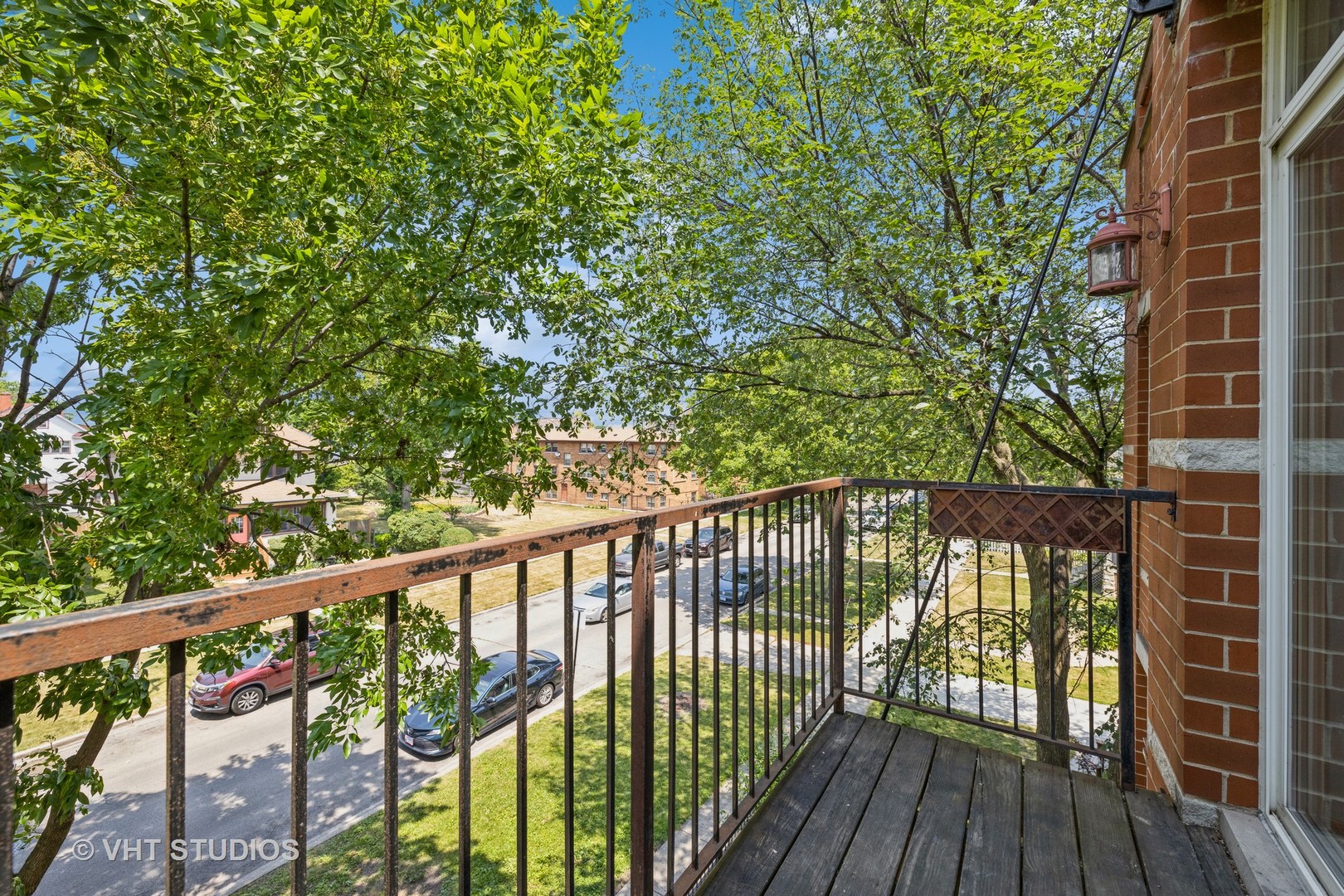 5931 West Huron Street, Unit 3N Chicago, IL 60644 - Photo 12 of 13 a view of a balcony with wooden floor