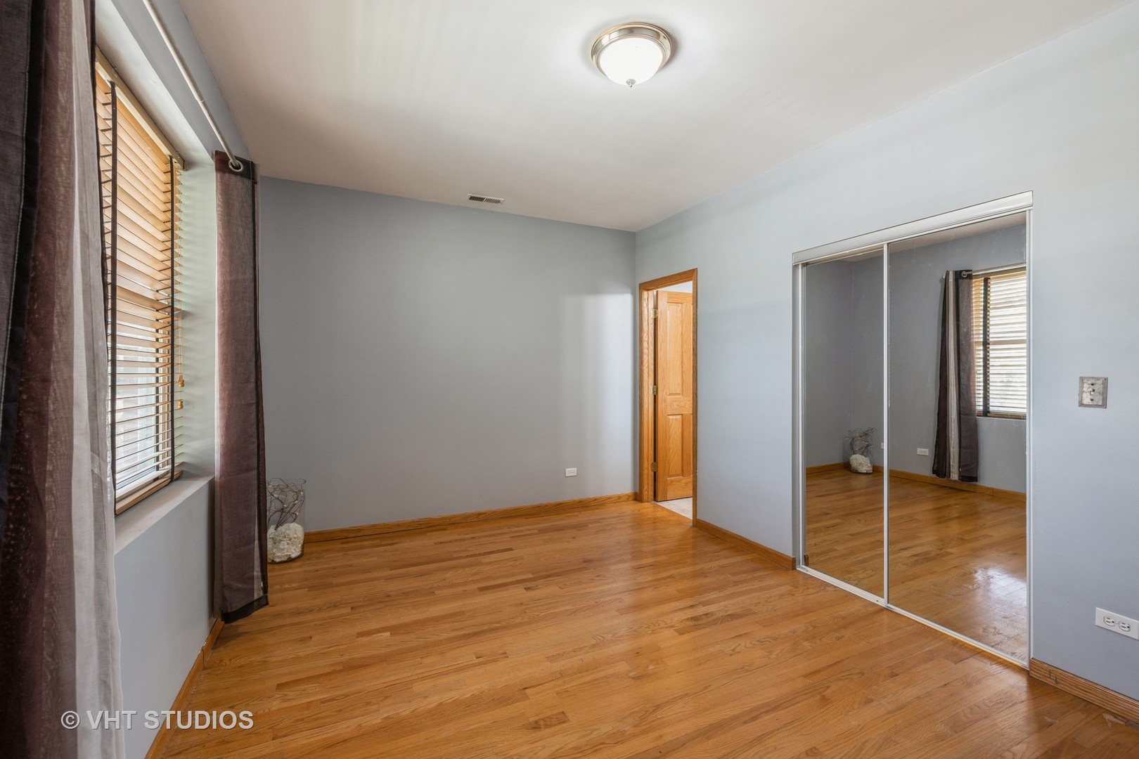 5931 West Huron Street, Unit 3N Chicago, IL 60644 - Photo 7 of 13 a view of an empty room with window and wooden floor