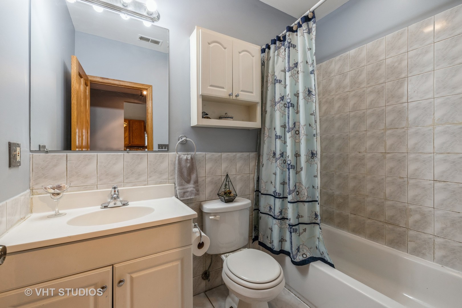 5931 West Huron Street, Unit 3N Chicago, IL 60644 - Photo 10 of 13 a bathroom with a bathtub shower sink mirror and toilet