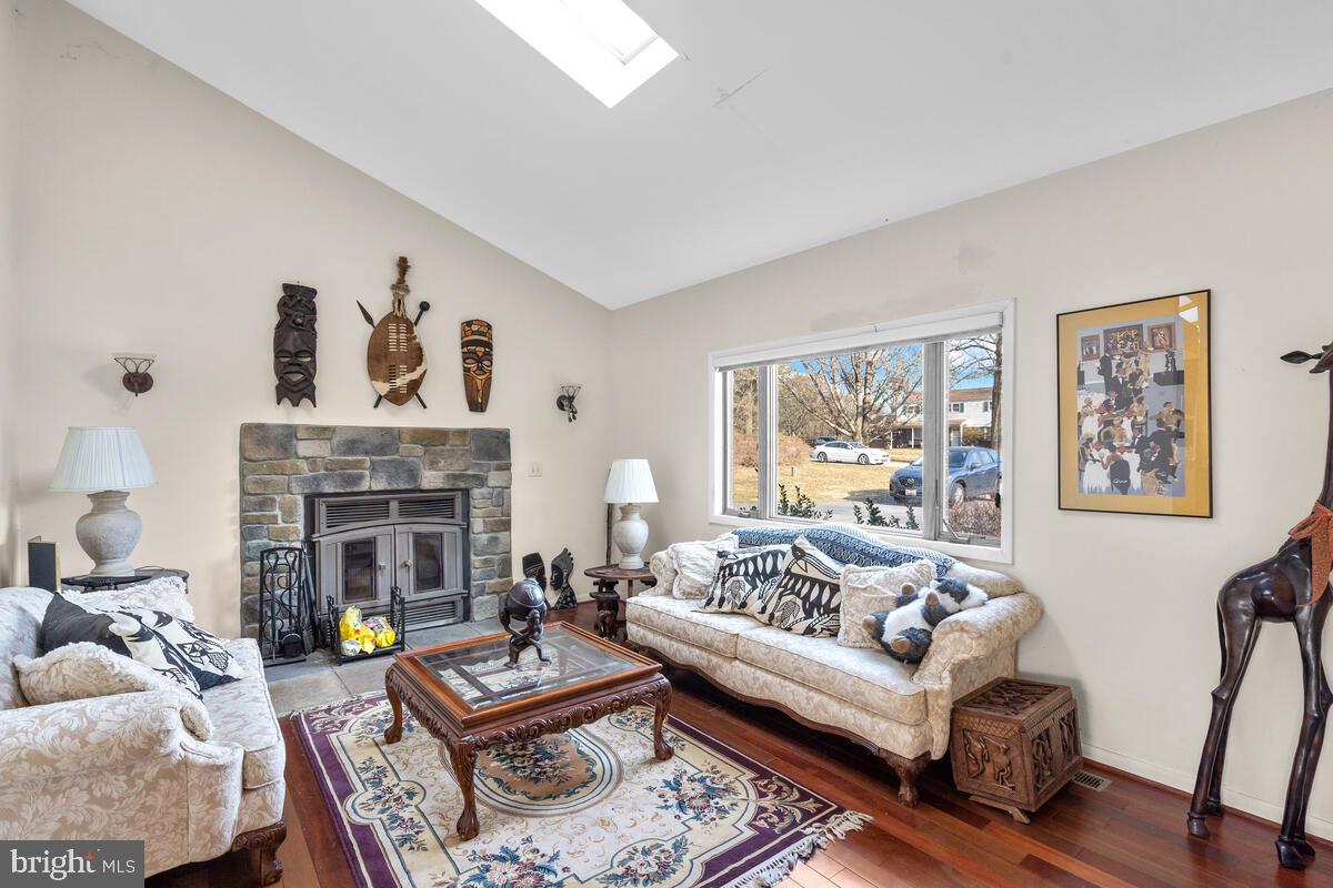 Living room w/ wood burning FP, vaulted ceilings