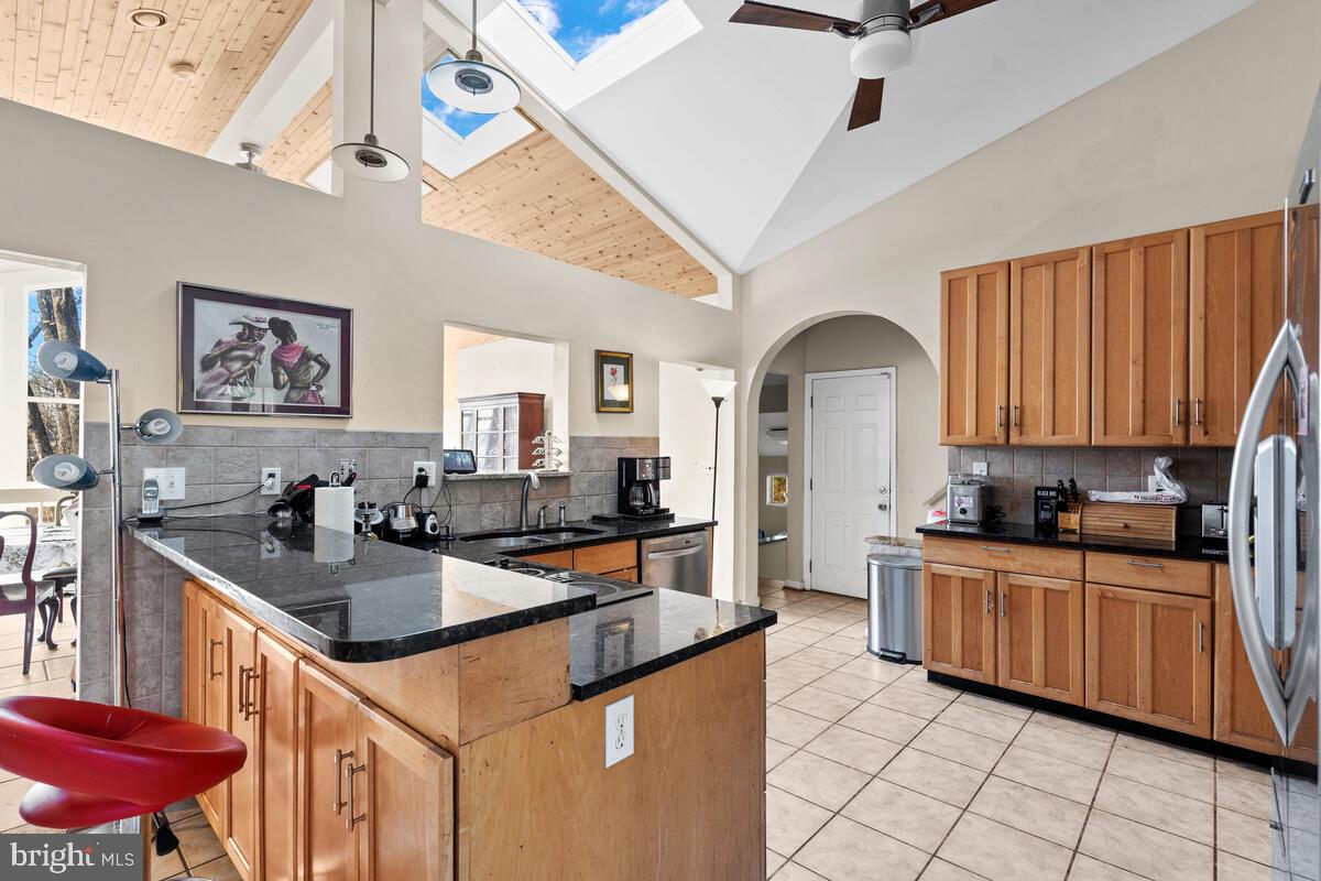 Gourmet kitchen w/ skylights & vaulted ceilings