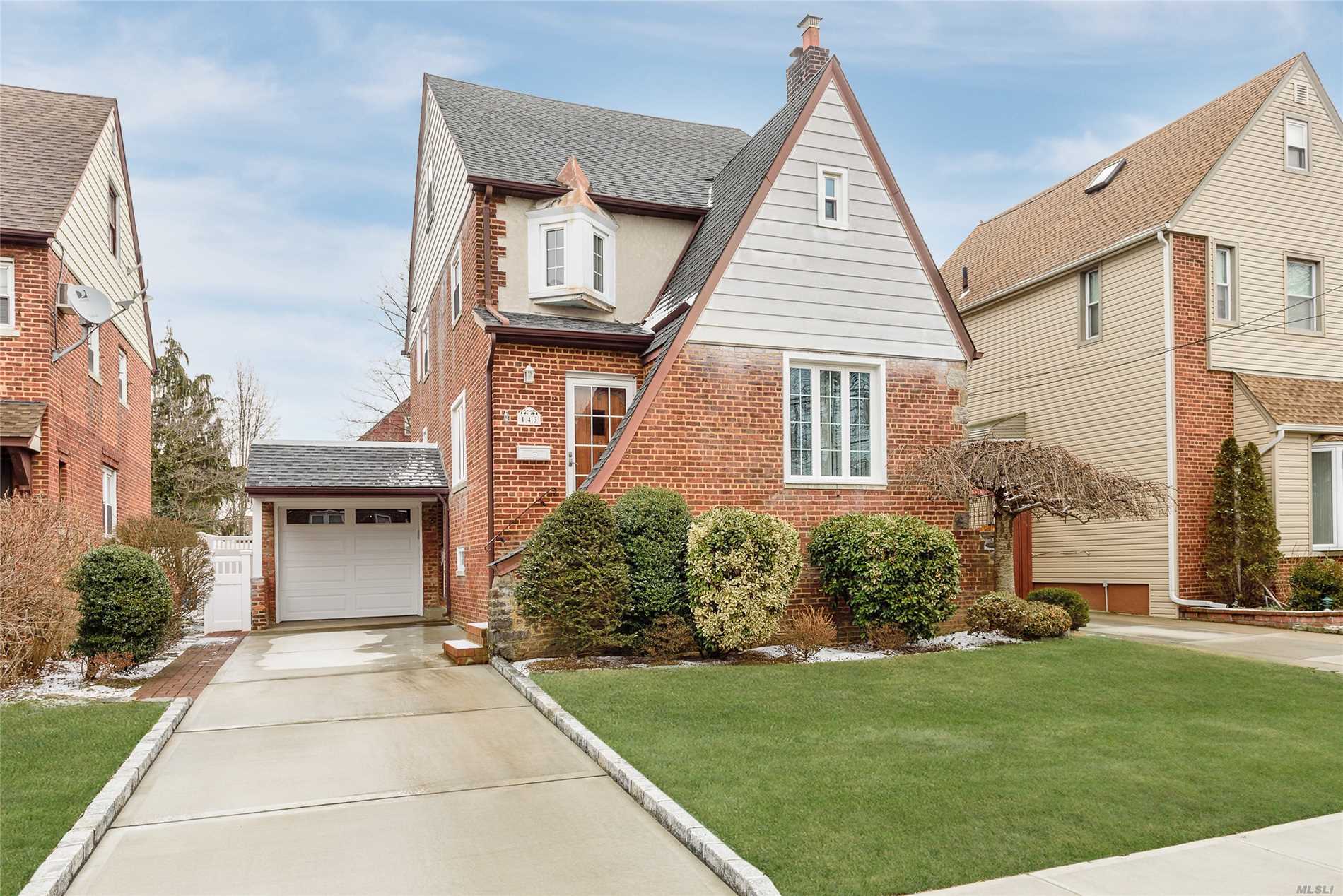 143 Amherst Road Valley Stream, NY 11581 - Photo 1 of 1 a front view of a house with a yard and garage